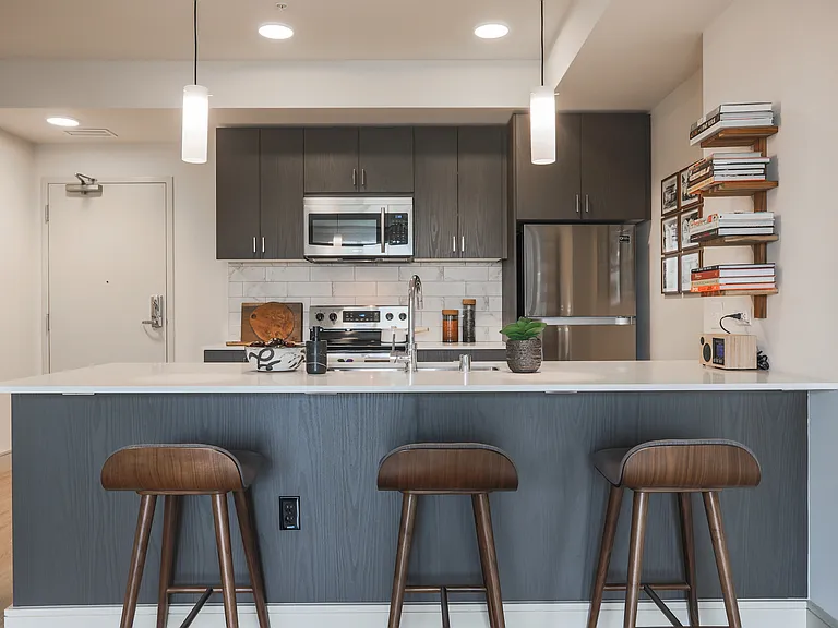 A sleek kitchen with island seating_perfect for meals, work, or gathering with friends.