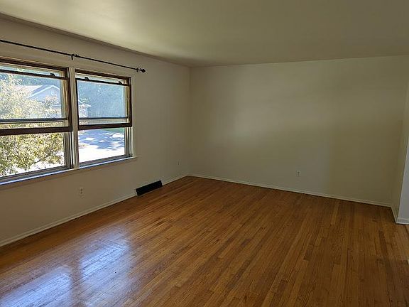 Large living room area with hardwood floors