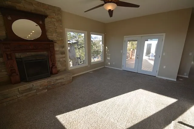 fireplace room looking at doors leading to deck