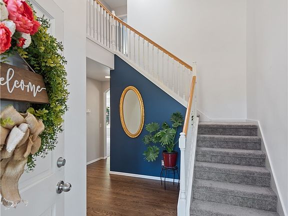 The grand staircase, skylights and updated lighting fixtures are just one of the many features to love about this home! 