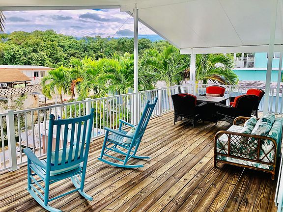 Freshly stained deck with multiple seating areas overlooking water