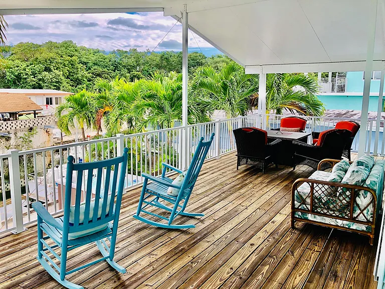 Freshly stained deck with multiple seating areas overlooking water