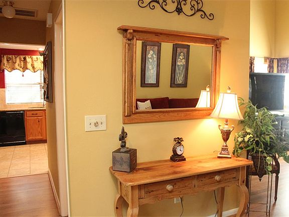 ENTRY HAS LAMINATE WOOD FLOORS AND NEUTRAL COLORS WHICH FLOW THROUGH THE MAIN LIVING AREA.