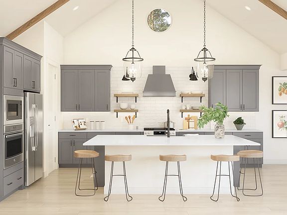 Kitchen with pendant lights and vaulted ceiling
