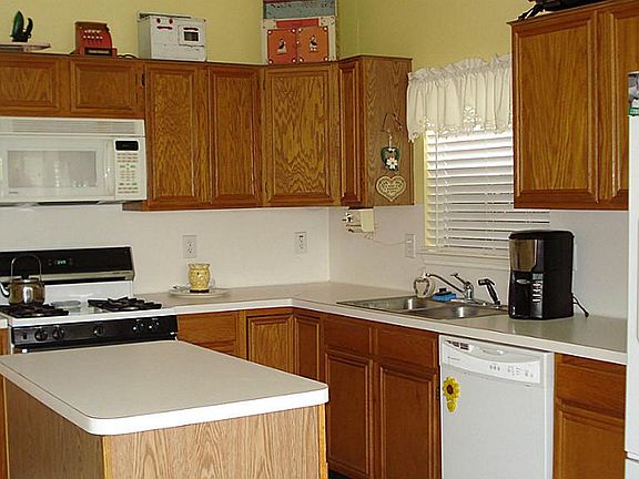 Kitchen with island work space, gas stove, tiled floors