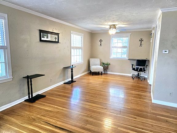 Living room, nice wood floors California blinds, Fan