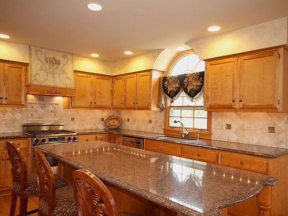Kitchen, custom exhaust hood, brass & tumbled marble backsplash