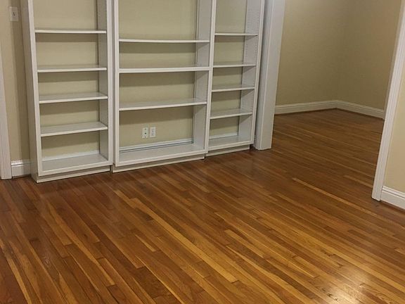 Full wall of bookshelves in living room