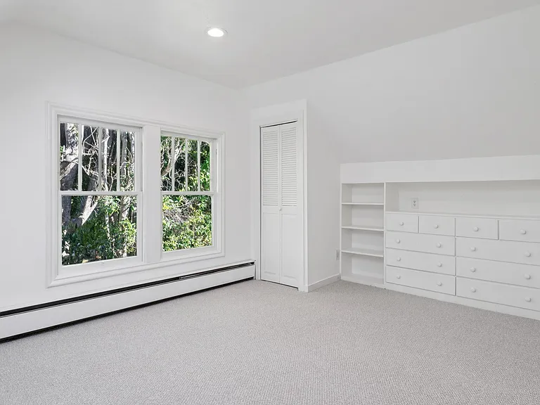 Upstairs bedroom #2 with built in drawers and closet.