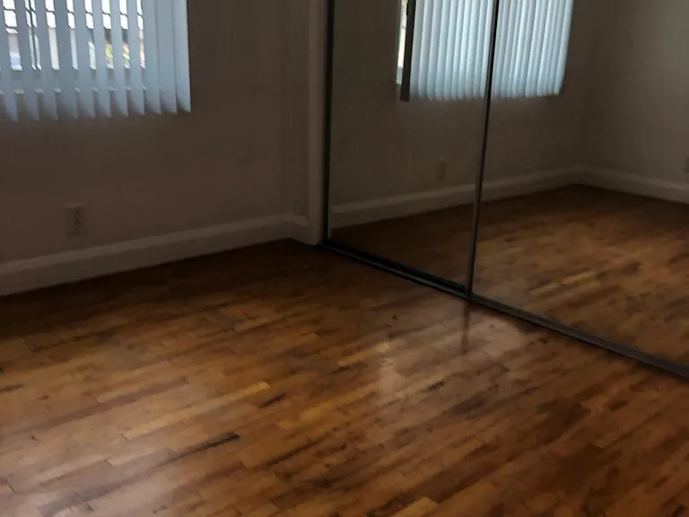 Bedrooms have a ceiling fan, mirror closet doors, blinds and original wood floors.