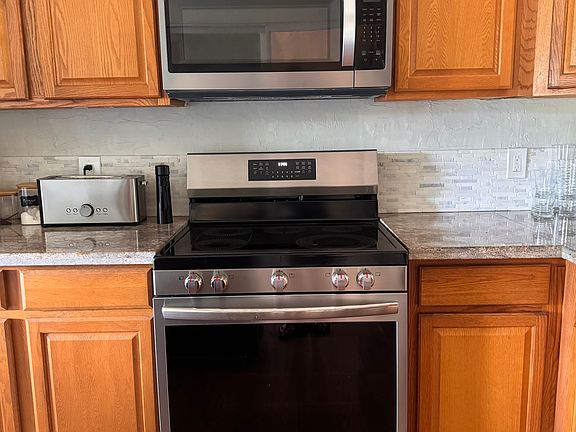 Kitchen with NEW appliances, dishwasher, refrigerator, stove, and microwave.