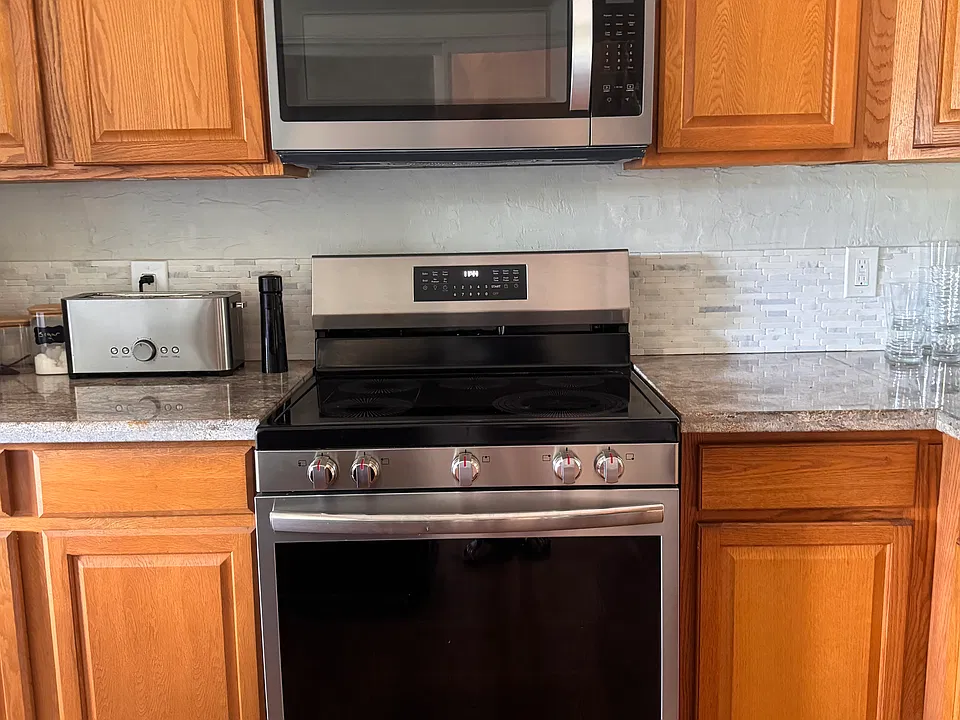 Kitchen with NEW appliances, dishwasher, refrigerator, stove, and microwave.