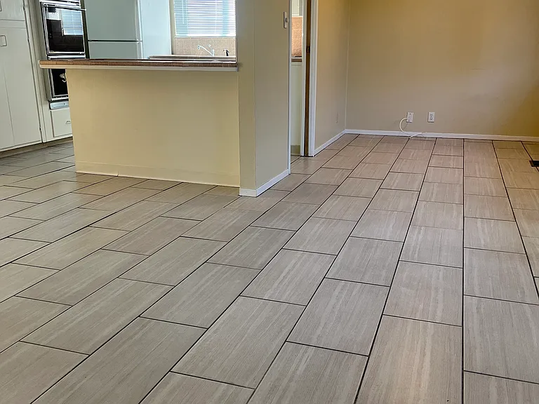 Huge tiled kitchen with room for office or other.