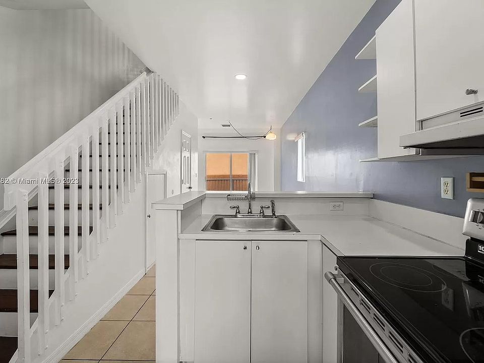 Kitchen: Offers an east-facing view towards the living room and guest bathroom.