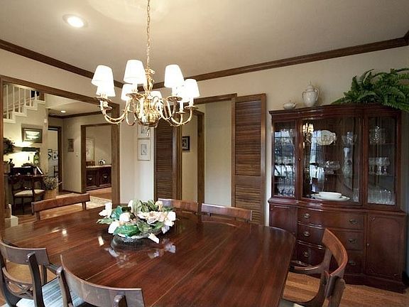 Formal dining room has hardwood floors and crown moldings.