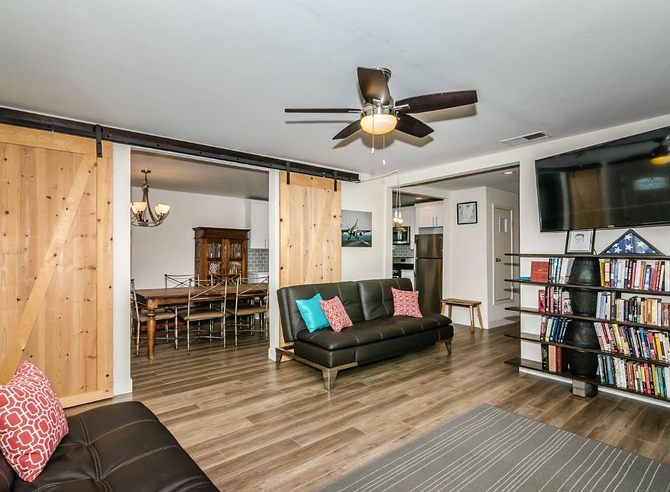 Living room and barn door style entry to dining room