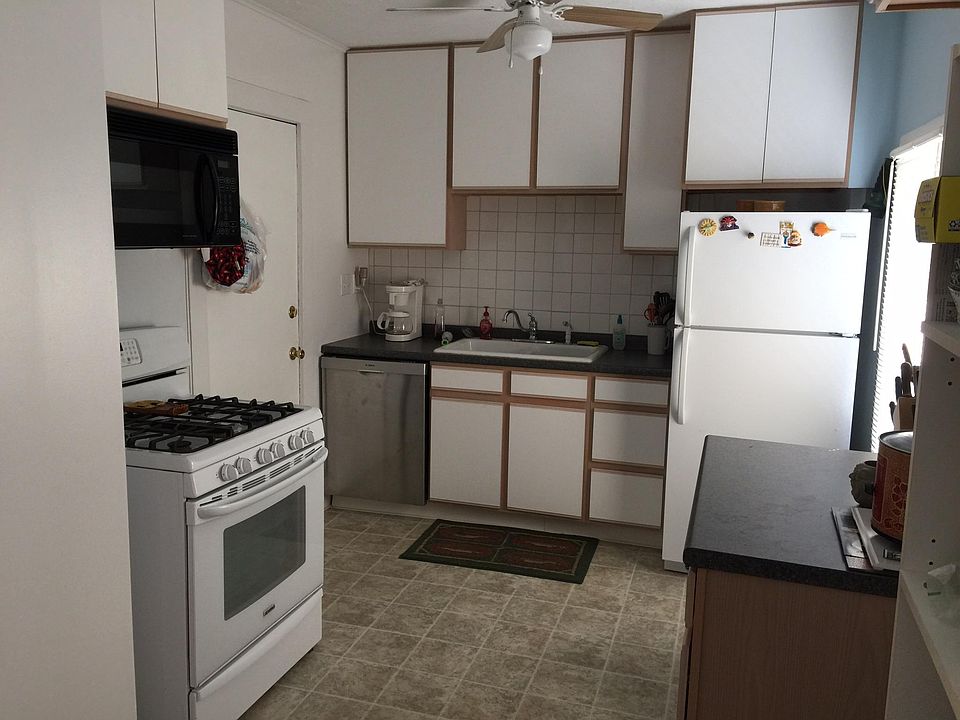 Kitchen w appliances range refrigerator dishwasher and microwave