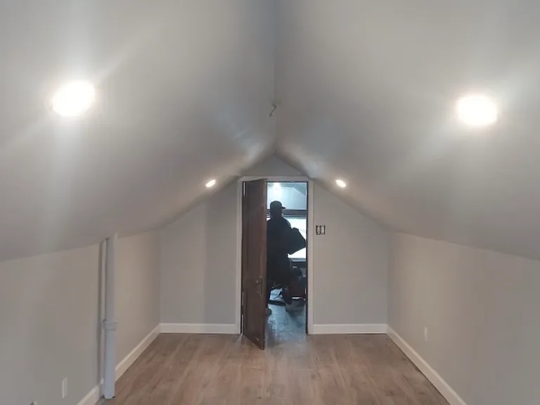 large finished bedroom with luxury vinyl plank flooring added in 2024