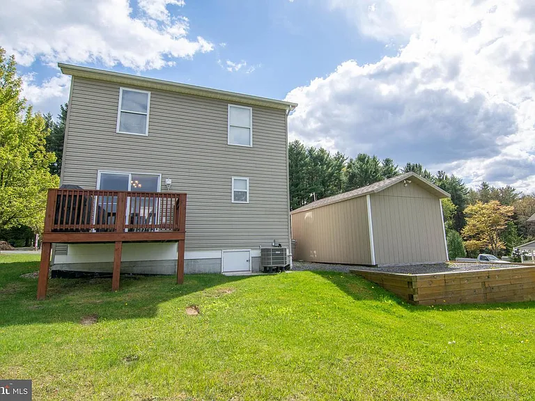 Back of house with patio and shed