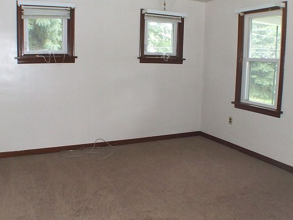 The living room boasts plenty of light and brand new carpet.