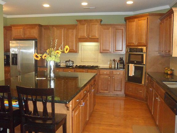 Chef Inspired Kitchen w/ island, granite, wood floors, etc..