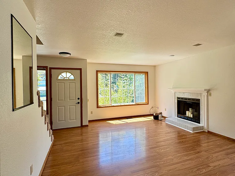 Front Door & Formal Living Room w/ Ornamental Fireplace