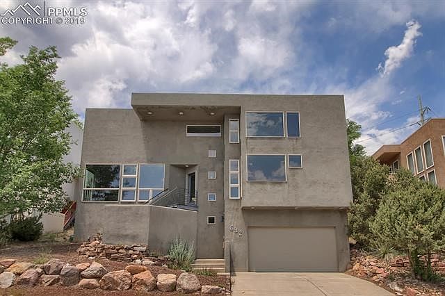 Modern, urban loft design features plentiful windows with a view of Old Colorado City and Cheyenne Mountain.