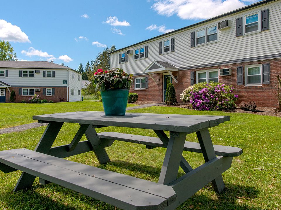 Elevate your outdoor gatherings at one of our inviting picnic tables, where blue skies and lush landscapes set the stage for memorable moments with friends.