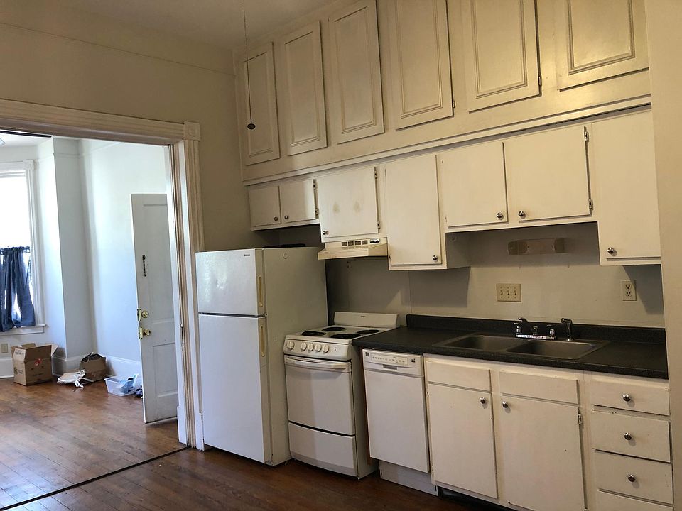 Kitchen with plenty of storage cabinets. High ceilings throughout.