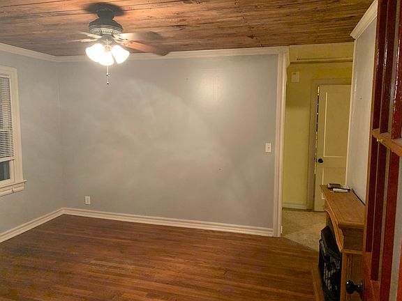 Den with fireplace & beautiful hardwood floors.