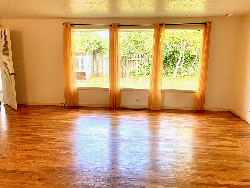 Large, open-concept living room. (Step-down den or 3rd bedroom off to left-side, separated by a door, and other bedrooms and bathroom to the right of living room.