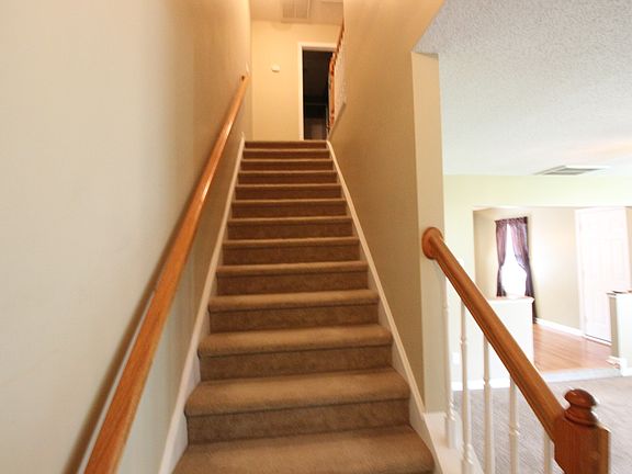 Stairs leading to bedrooms 2 and 3 and full bath