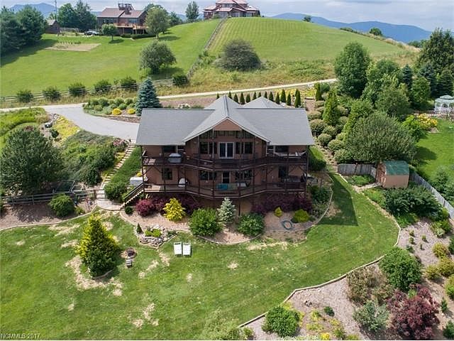 Front of the home with views of the beautiful landscaping, shrubs, flowers and trees.