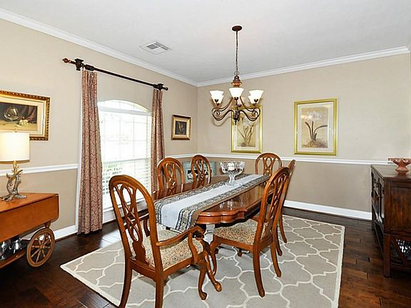 THE LARGE DINING ROOM IS RIGHT OFF THE ENTRY AND  FEATURES WOOD FLOORING & LOTS OF MILLWORK AND TRIM, THE WINDOW LOOKS OUT TO THE FRONT ACREAGE. THIS ROOM IS GREAT FOR ENTERTAINING OR FOR A LARGE DINNER PARTY!