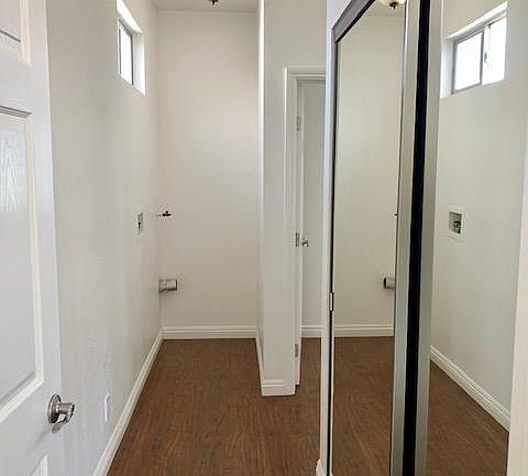 Hallway leading to bedrooms. Closet on the right and space for stackable washer and dryer at the end.