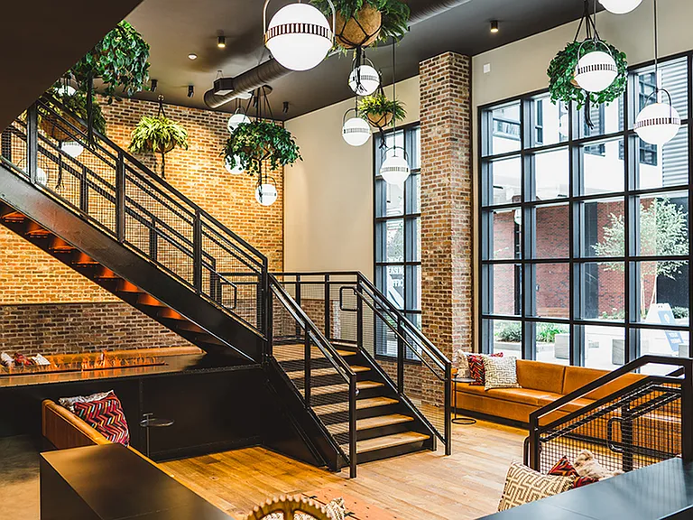Exquisite two-story lobby with serene setting and fire pit
