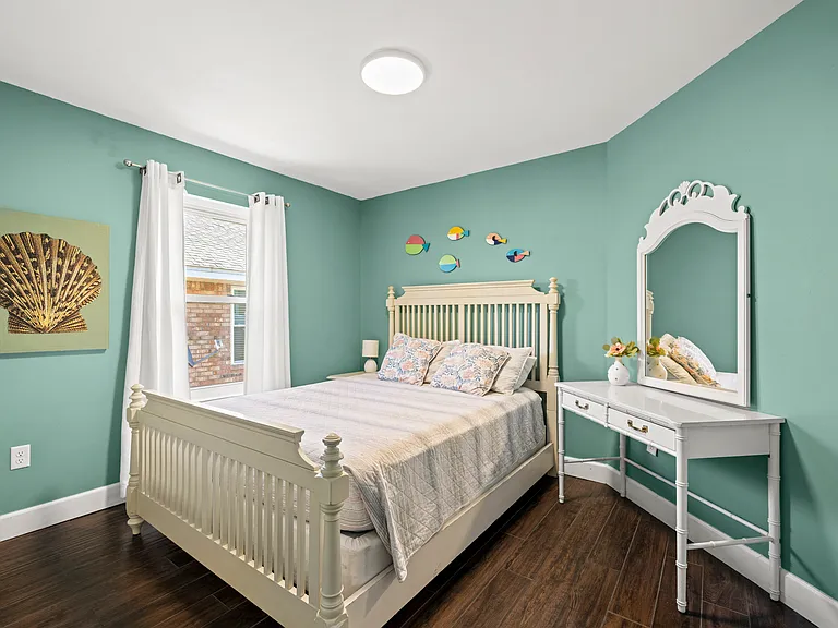 Bedroom 2 is bright and inviting, with comfortable bedding, modern furnishings, and plenty of closet space.