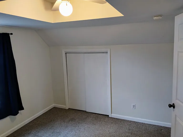 Closet & ceiling fan in small bedroom.