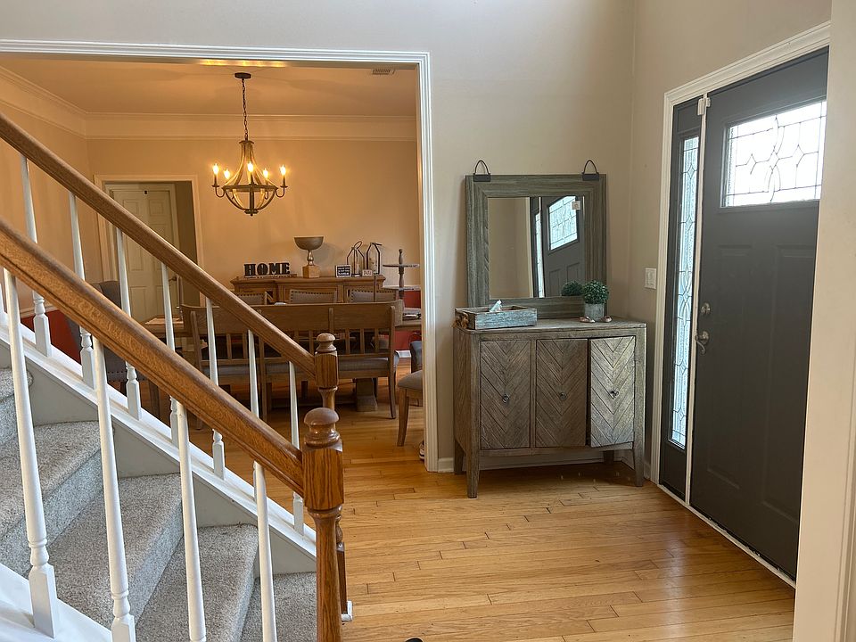 Bright and welcoming entryway that opens to a formal dining room on the right and a private office on the left, creating a natural and functional flow.