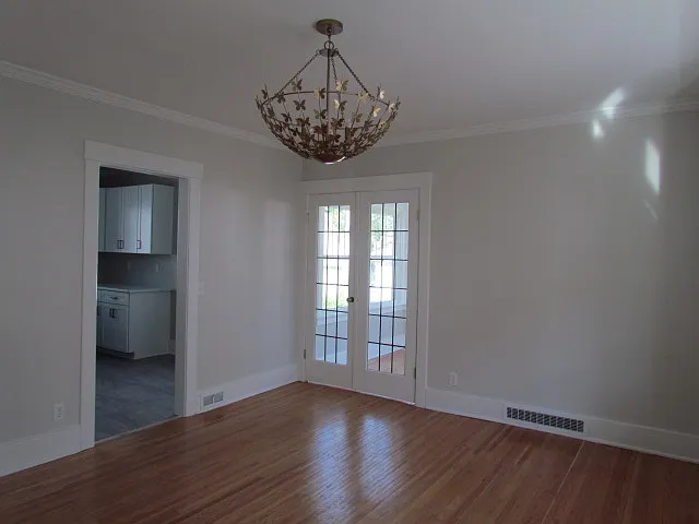 View of Dining Room from the Living Room. These leaded doors lead into a full season den/office/playroom