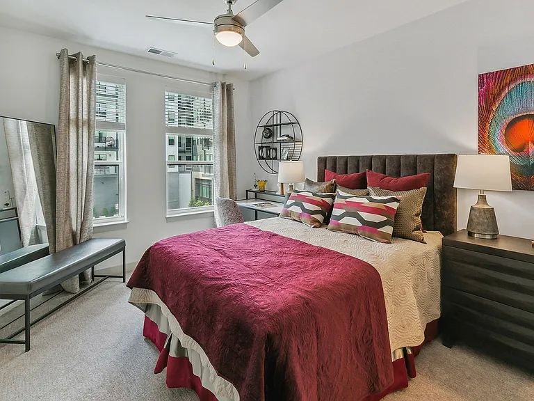 Rest easy in a thoughtfully designed bedroom that blends comfort, color, and natural light.
