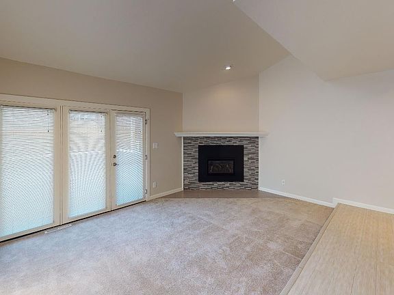 Main floor living room with gas fireplace and patio