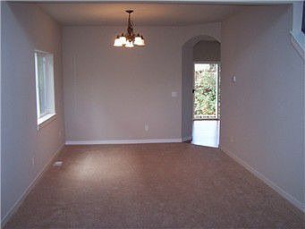 dining room with archway to kitchen