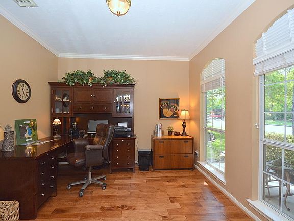 Spacious study offers crown, large windows & wood floors and looks out to the front porch.