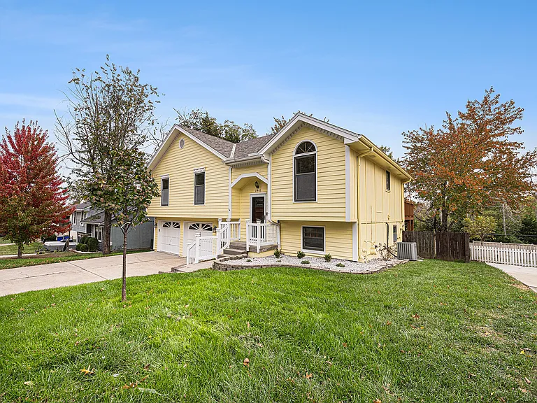 A welcoming front yard with open space and greenery sets the tone for the home, offering a charming and inviting first impression.
