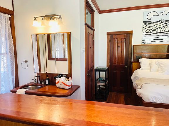 The bathroom sink and vanity is to the left