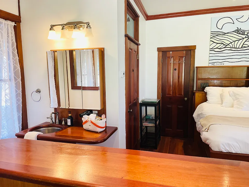 The bathroom sink and vanity is to the left