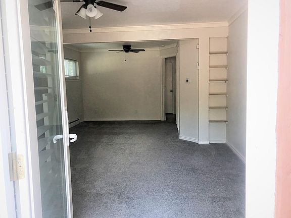 Opening front door into combined living room and bedroom area.