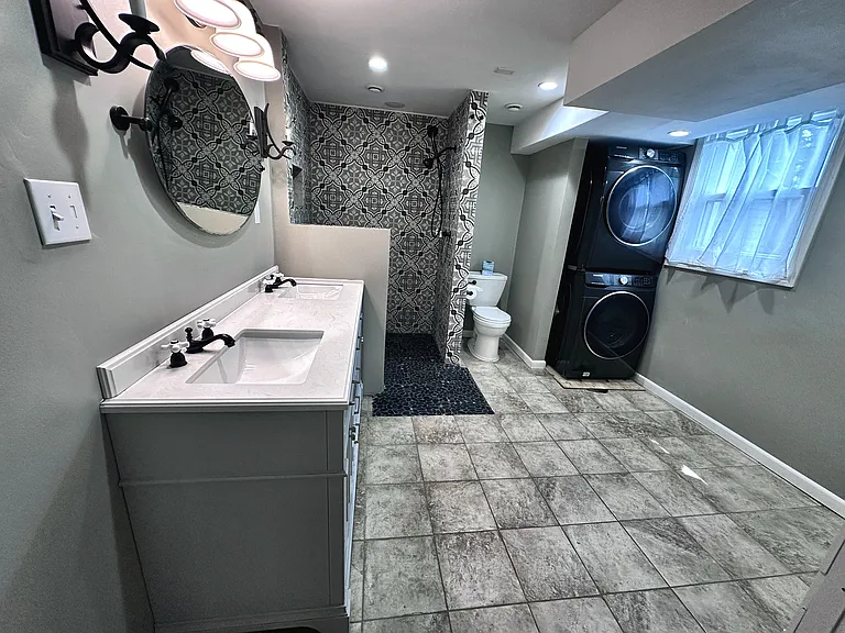 Full Bathroom with Laundry room with Dual Vanity bathroom and storage