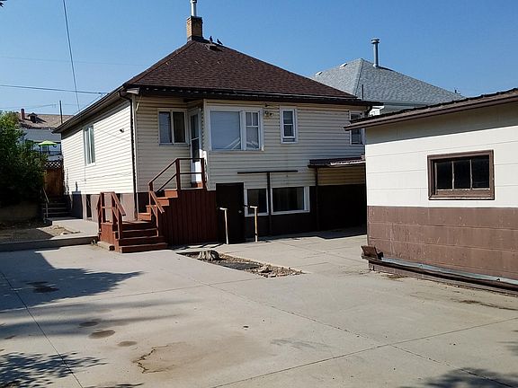 2- level house with concrete back yard and garage